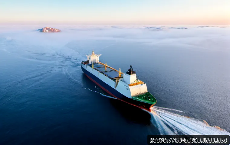 Home 17 해양 항로 자동화 기술 - Photorealistic autonomous cargo ship navigating a calm northern sea route at dawn, elevated three-qu...